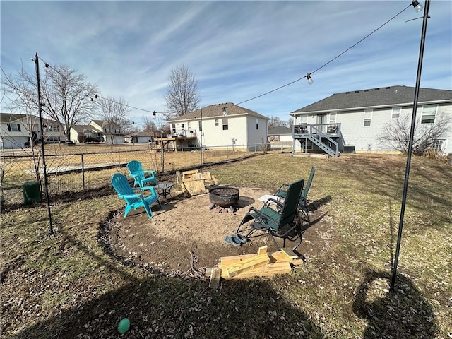 view of yard featuring a wooden deck and an outdoor fire pit