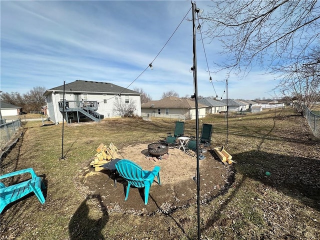 view of yard with a deck and an outdoor fire pit