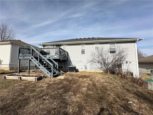 back of house with a wooden deck and central AC unit