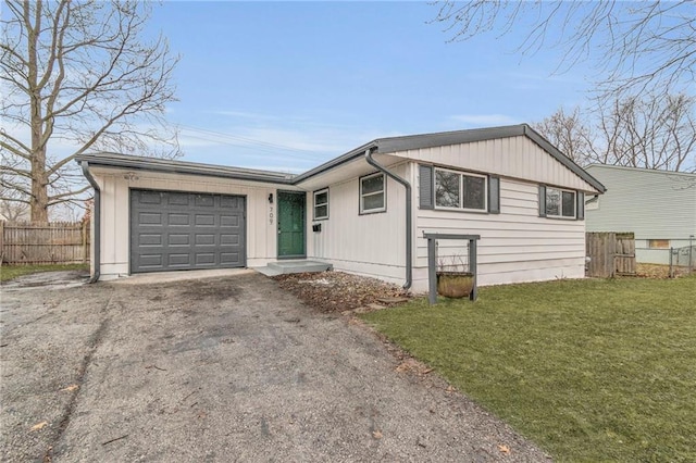 view of front of home with a garage and a front lawn