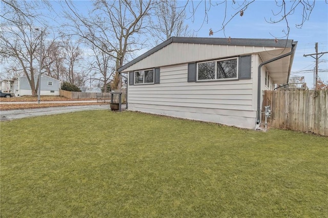 view of side of home with a lawn