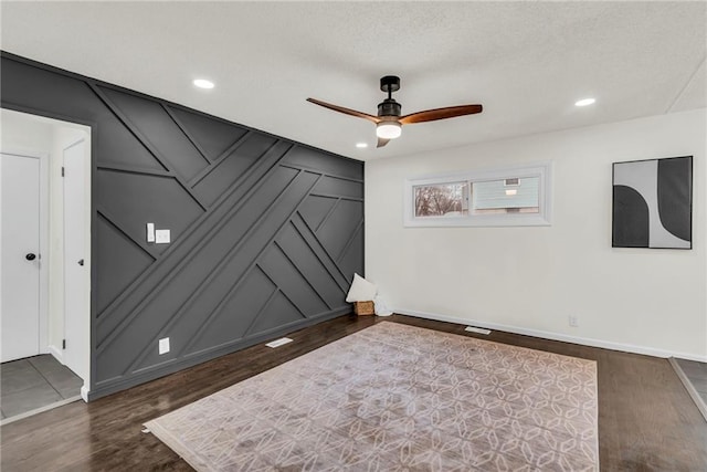 unfurnished room featuring dark hardwood / wood-style floors and ceiling fan