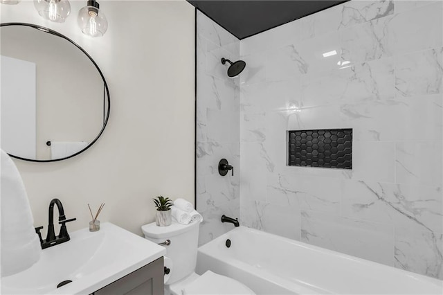 full bathroom featuring tiled shower / bath, vanity, and toilet