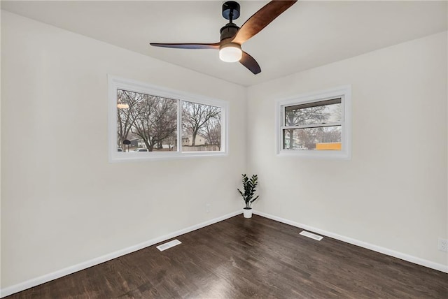 unfurnished room with ceiling fan and dark hardwood / wood-style floors