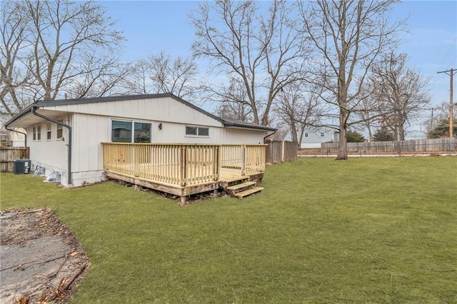 back of house featuring cooling unit, a lawn, and a deck