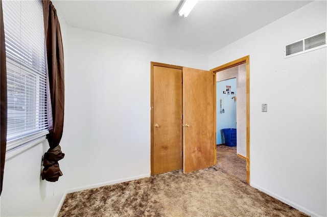 bedroom with a closet and light carpet