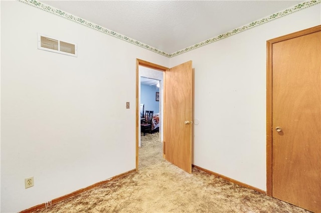 empty room with light colored carpet