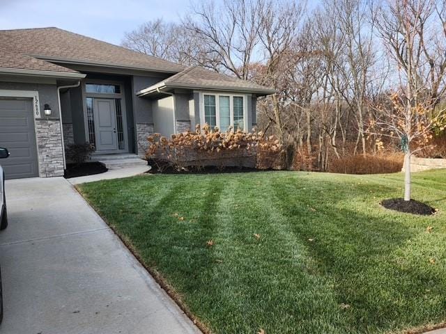 view of front of house with a garage and a front yard