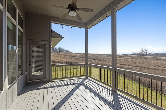 deck featuring a rural view and ceiling fan