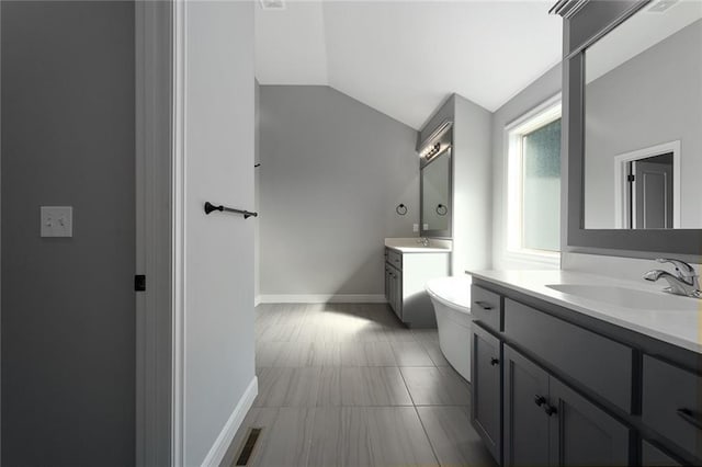 bathroom with vanity and vaulted ceiling