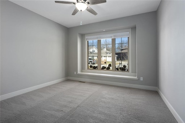 carpeted spare room with ceiling fan