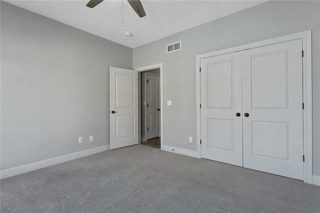 unfurnished bedroom with carpet floors, ceiling fan, and a closet