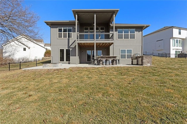 back of property featuring a patio, a balcony, a yard, and a bar