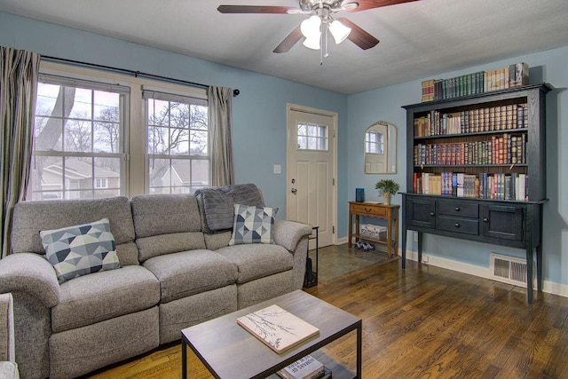 living room with ceiling fan and dark hardwood / wood-style floors