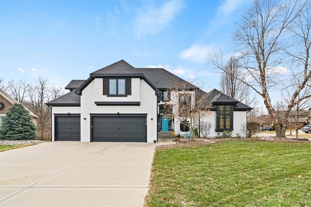 view of front of house with a garage and a front lawn