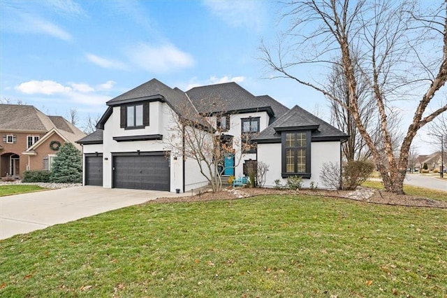 view of front of property featuring a garage and a front yard