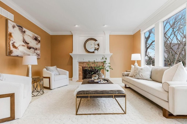 living room featuring a tile fireplace, crown molding, and light colored carpet