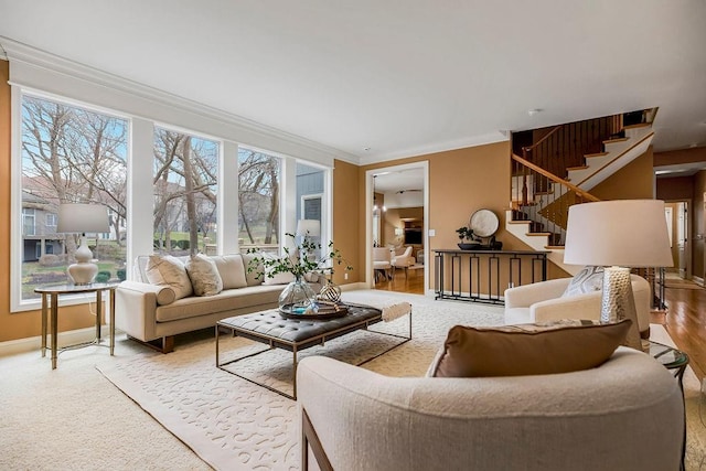 living room with crown molding and a healthy amount of sunlight