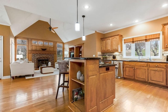 kitchen with stainless steel dishwasher, a kitchen breakfast bar, a kitchen island, pendant lighting, and decorative backsplash