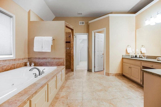 bathroom featuring tile patterned flooring, vanity, and shower with separate bathtub