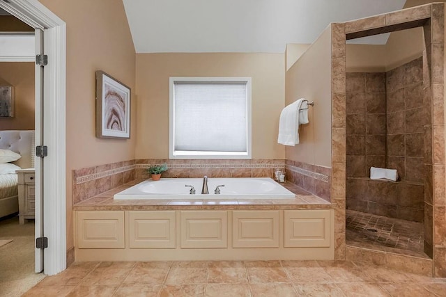 bathroom featuring independent shower and bath and tile patterned flooring