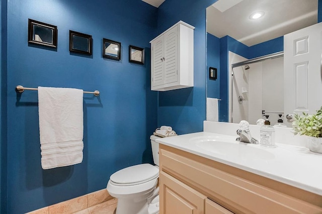 bathroom with an enclosed shower, vanity, tile patterned floors, and toilet