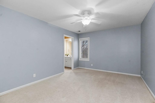 carpeted spare room with ceiling fan