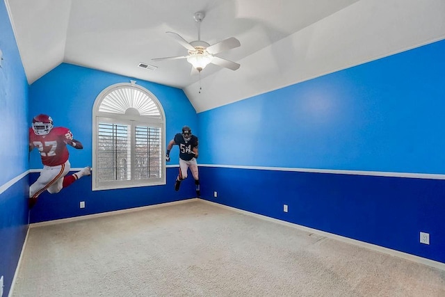 carpeted empty room with lofted ceiling and ceiling fan