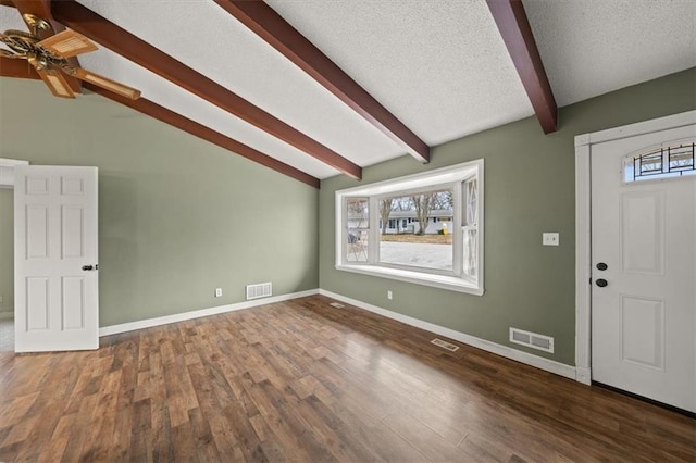 foyer entrance featuring lofted ceiling with beams, ceiling fan, a textured ceiling, and dark hardwood / wood-style flooring