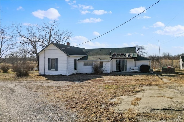 view of front of home with a chimney and an attached garage