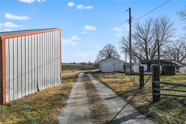 view of road featuring dirt driveway