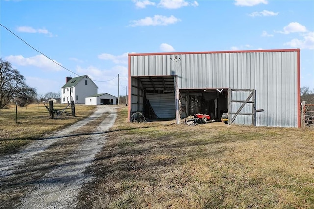 view of pole building featuring driveway