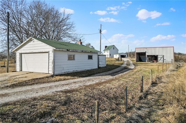 detached garage featuring concrete driveway