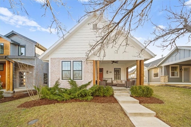 bungalow featuring a front yard, ceiling fan, and a porch