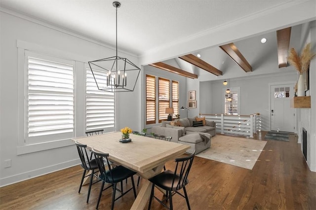 dining area featuring ornamental molding, vaulted ceiling with beams, an inviting chandelier, and dark hardwood / wood-style flooring