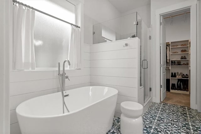 bathroom with tile patterned floors and shower with separate bathtub