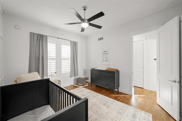 bedroom featuring hardwood / wood-style floors and ceiling fan