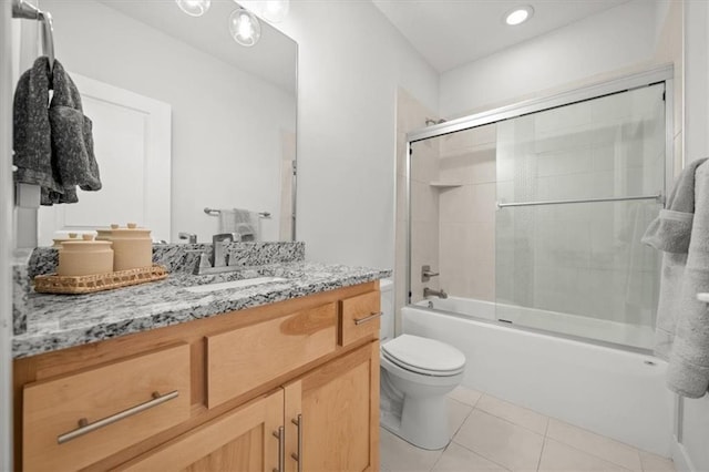 full bathroom with enclosed tub / shower combo, toilet, tile patterned floors, and vanity