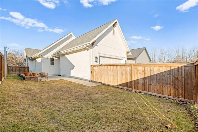 back of property featuring a lawn and a patio