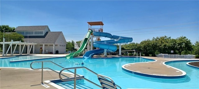 view of swimming pool featuring a pergola and a water slide