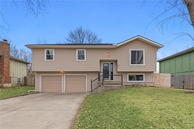 bi-level home with a garage and a front lawn