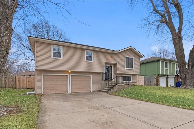 raised ranch with a garage and a front lawn