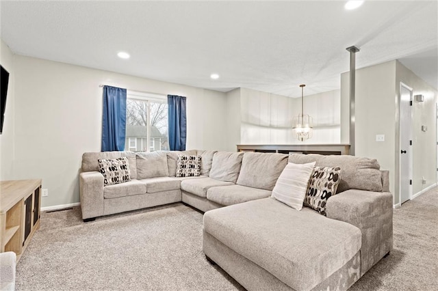 carpeted living room with a chandelier