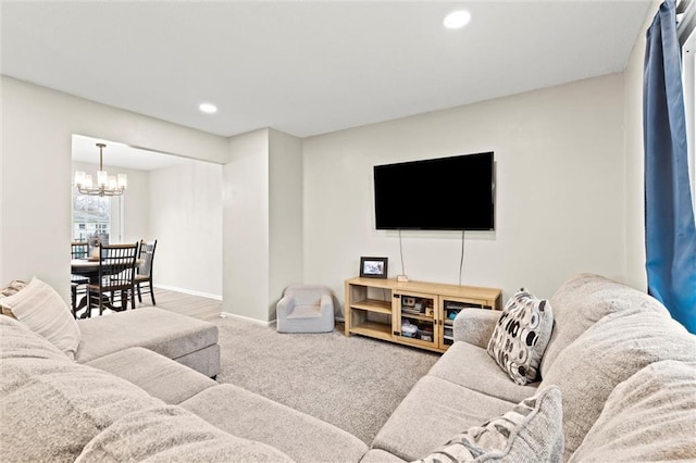 carpeted living room featuring a notable chandelier