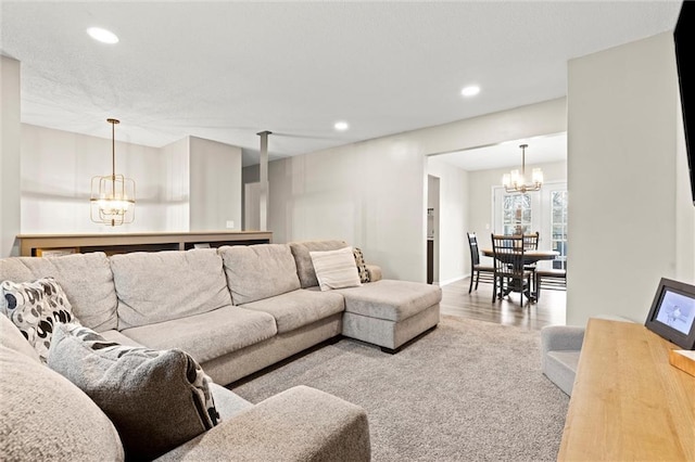 living room featuring an inviting chandelier and hardwood / wood-style flooring