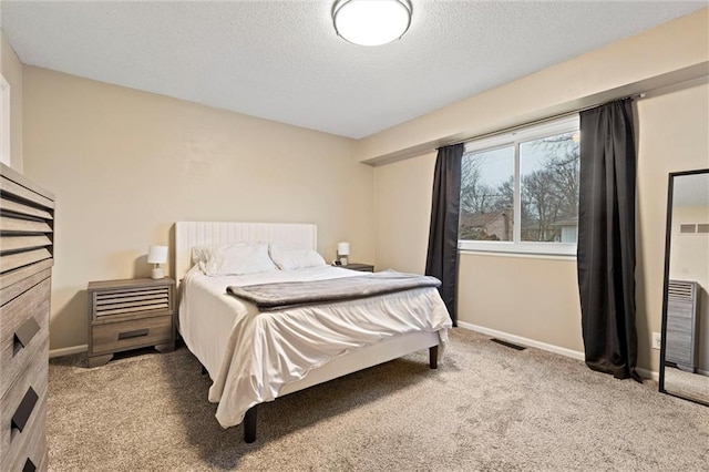 carpeted bedroom featuring a textured ceiling