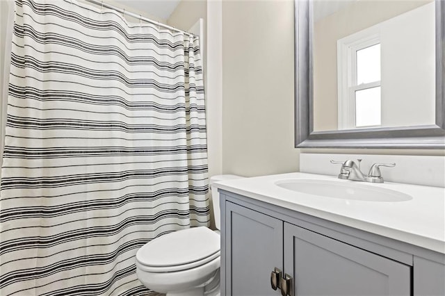 bathroom with vanity, toilet, and a shower with shower curtain