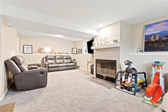 carpeted living room featuring a tiled fireplace