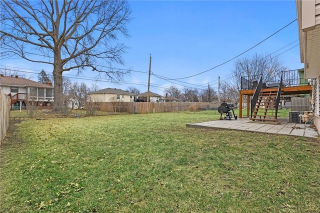 view of yard with central AC unit, a deck, and a patio area