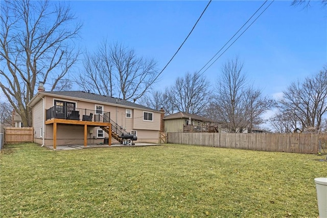 back of house with a lawn and a deck